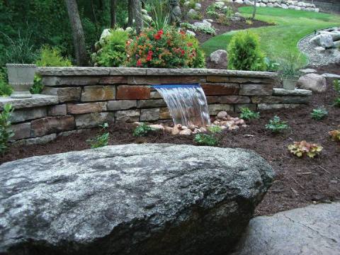 Stone waterfall and flower bed landscaping by Morris Lawn Service